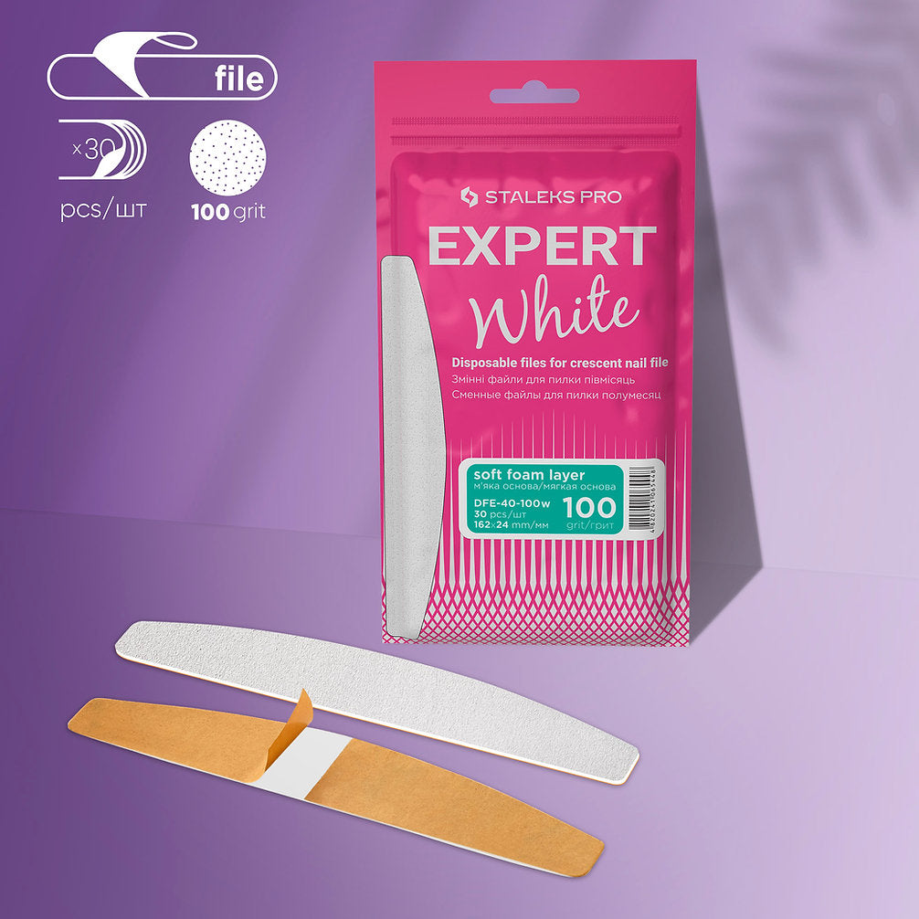 A Staleks PRO Disposable White Files for Crescent Nail File EXPERT 40 (30 pcs) pack with crescent-shaped, 100 grit, soft foam layer adhesive files is displayed on a purple background—perfect for artificial nails.