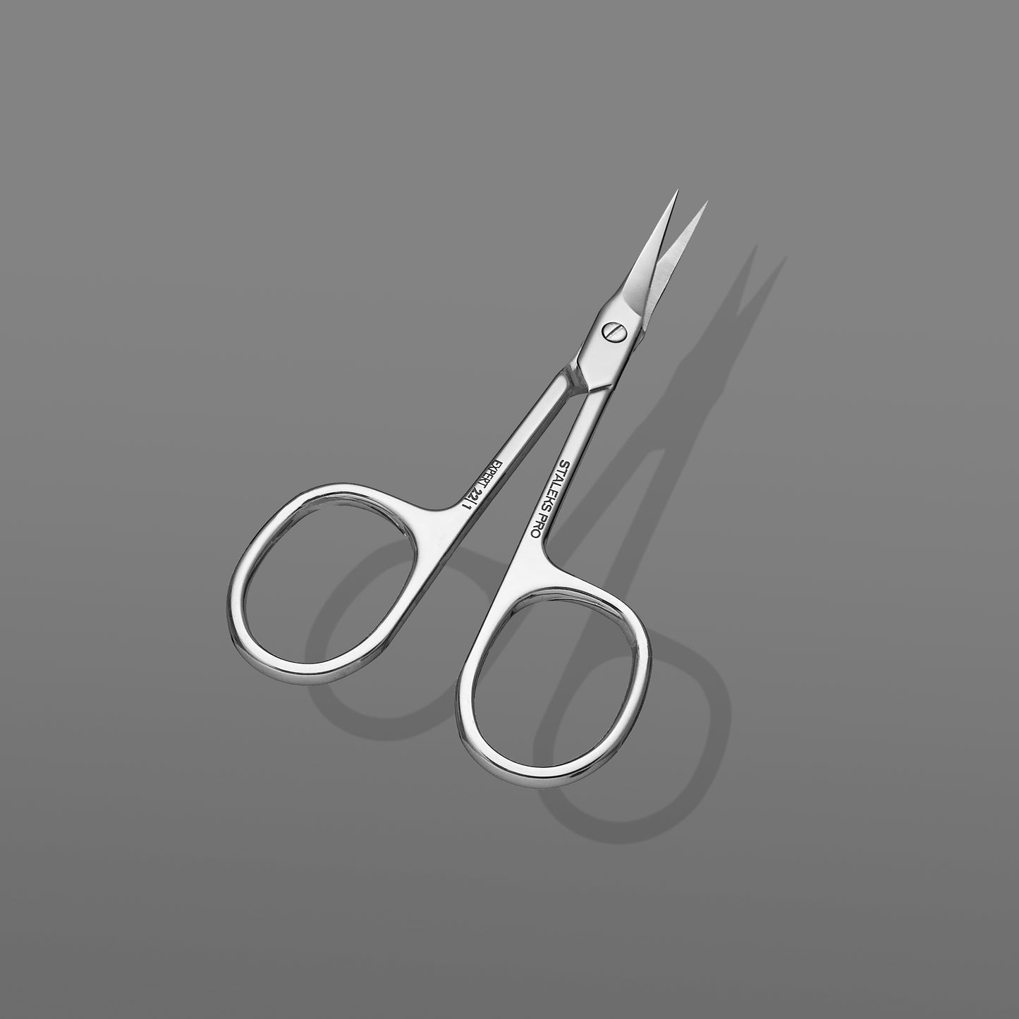 A small pair of Staleks PRO Professional cuticle scissors EXPERT 22 TYPE 1 with sharp, pointed tips and shiny metal surfaces, ideal for cuticle cutting, positioned diagonally on a plain gray background.