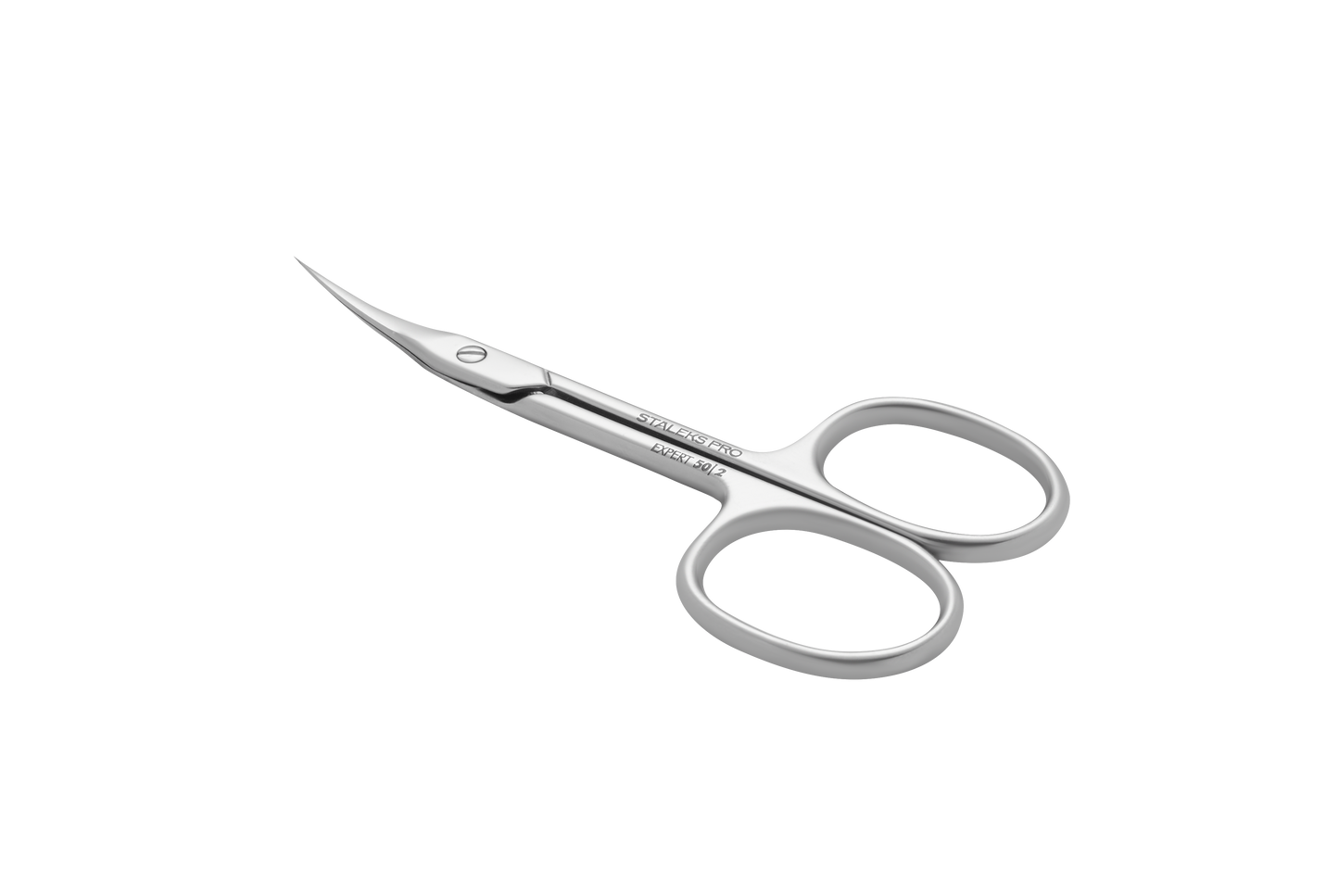 A pair of Staleks cuticle scissors with blade curve, resting on a light gray surface. The scissors feature looped handles and are positioned diagonally in the image.