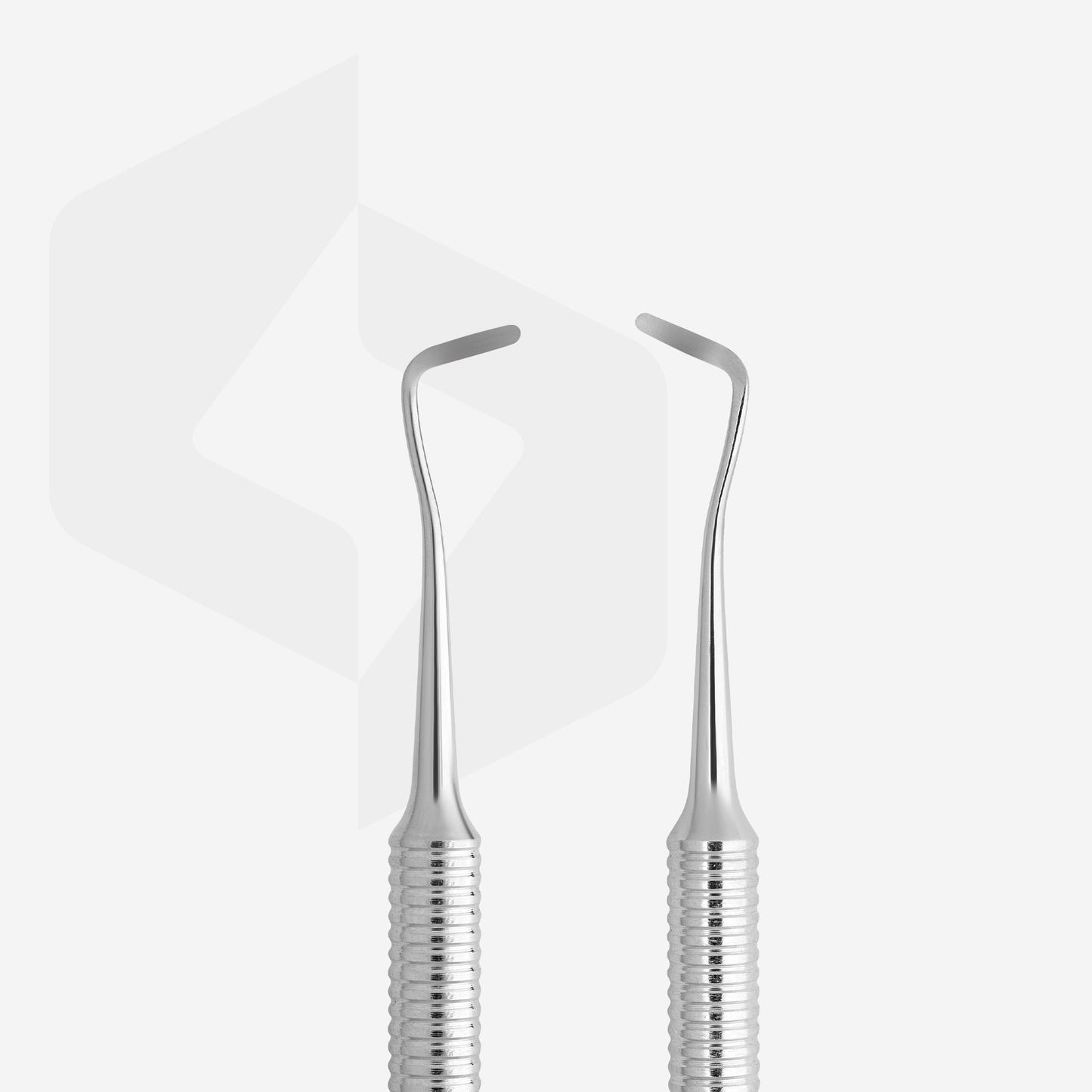 Two Staleks dental tools with curved, pointed ends and non-slip handles, displayed in front of a white, reflective background.