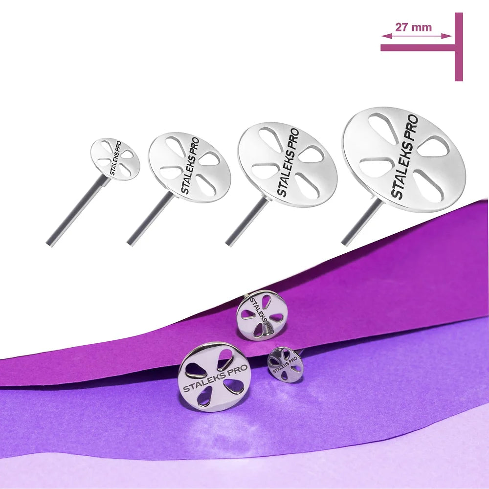 Five stainless steel STALEKS PRO Pedicure Disc PODODISC tools by Staleks are shown in decreasing size, with the largest labeled 27 mm. They rest on a white surface accented by layered purple paper at the bottom.