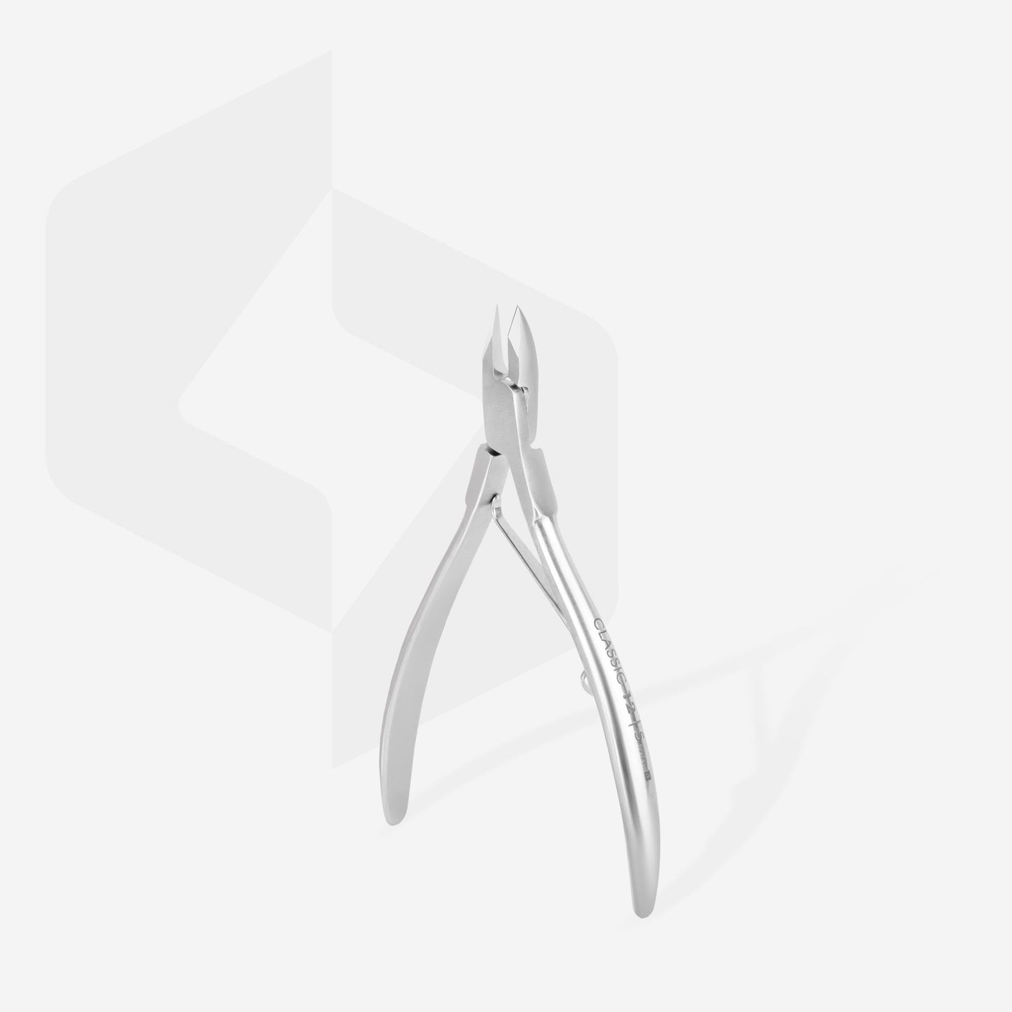 The STALEKS PRO Cuticle Nippers 5 mm half jaw CLASSIC 12 by Staleks, crafted from medical-grade stainless steel, gleam on a light backdrop. The ergonomic design features open handles and upward-facing blades against a subtle geometric pattern.