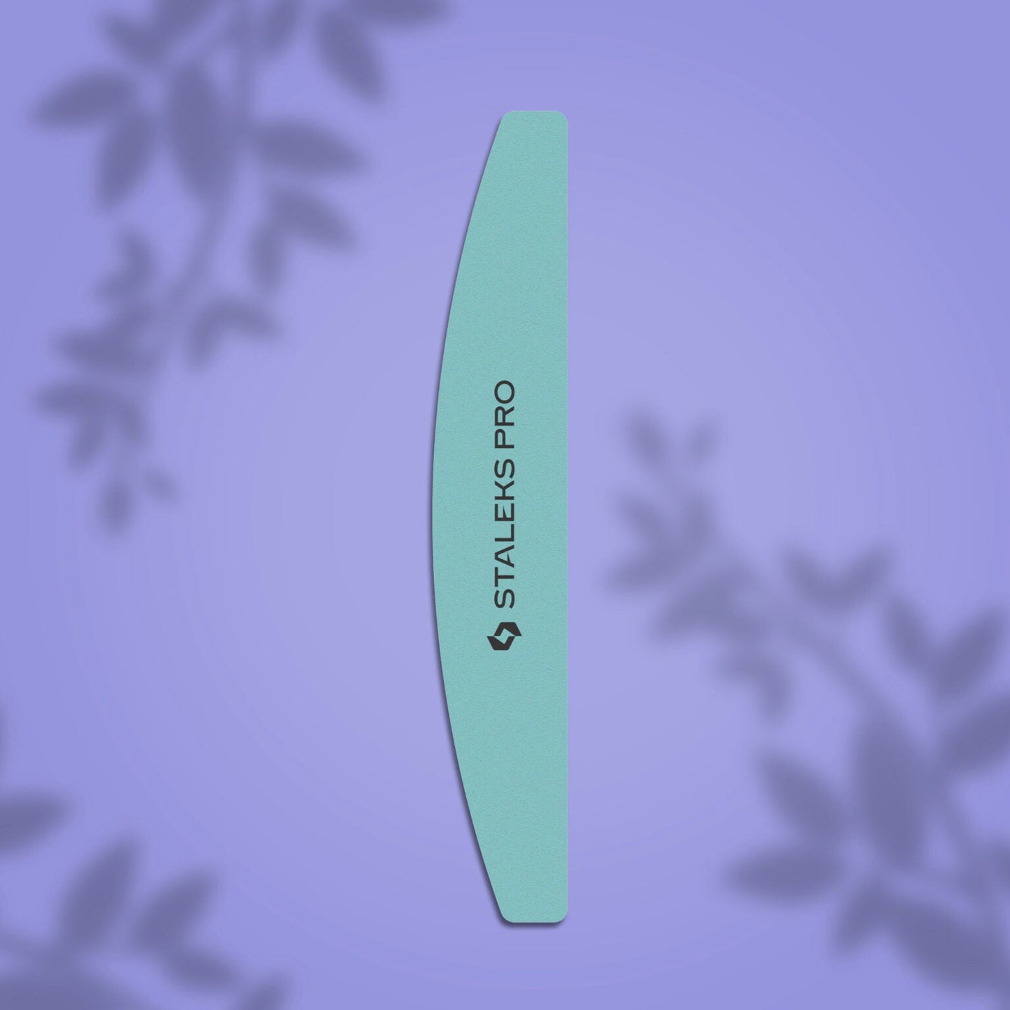 A STALEKS PRO Polishing Buff Crescent Expert 41 (400/3000 grit, 1 pc) stands vertically on a purple background with blurred leaf patterns—ideal for manicure and pedicure routines.