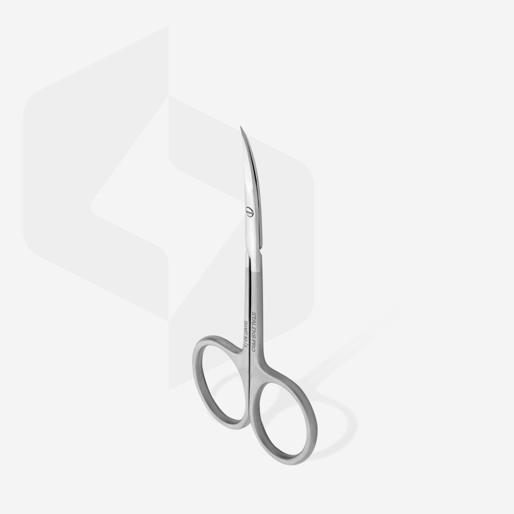 The STALEKS PRO Professional Cuticle Scissors SMART 10 TYPE 3 by Staleks are small, high-alloy stainless steel scissors with curved, pointed blades and rounded finger holes, shown upright on a white background with a faint geometric shape.