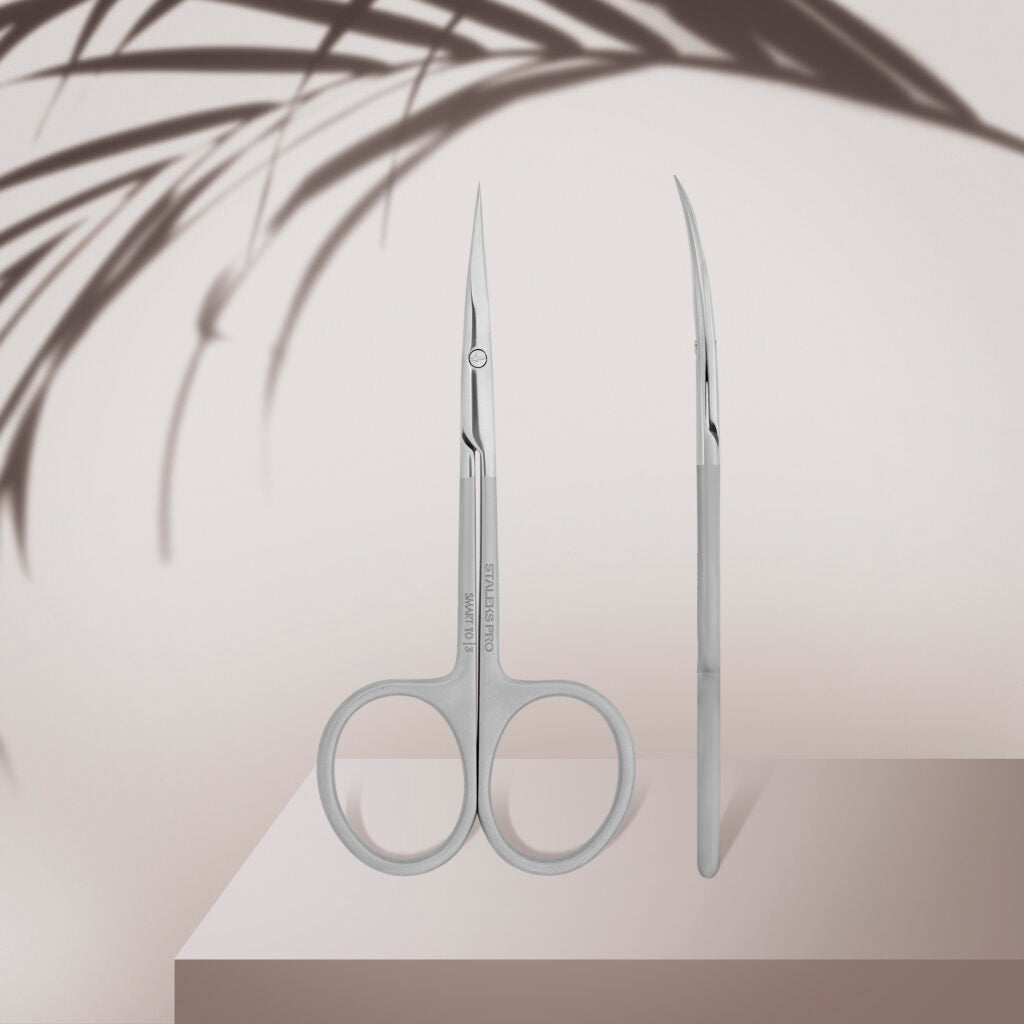 The STALEKS PRO Professional Cuticle Scissors SMART 10 TYPE 3 by Staleks are shown upright—one with a front view, the other side profile—against a light background with palm leaf shadows.