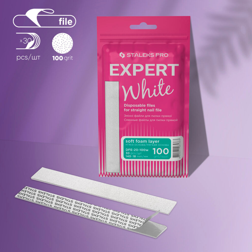 A pink package labeled "Staleks PRO Disposable White Files For Straight Nail File on Soft Foam Layer EXPERT 20 (30 pcs)" is displayed on purple. Two silver adhesive-backed nail files, one flipped to show text, are in front.