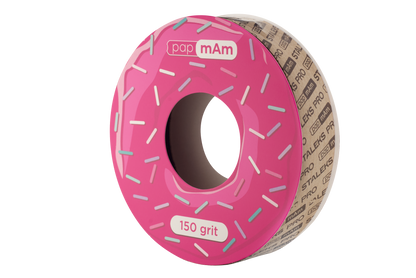 A roll of Staleks PRO papMam White Disposable Abrasive Tape File EXPERT designed to resemble a pink frosted donut with colorful sprinkles, labeled "150 grit" on the side.