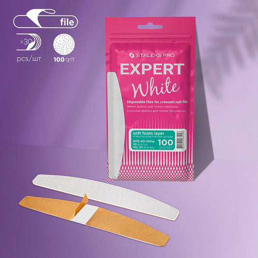 A Staleks PRO Disposable White Files for Crescent Nail File EXPERT 40 (30 pcs) pack with crescent-shaped, 100 grit, soft foam layer adhesive files is displayed on a purple background—perfect for artificial nails.