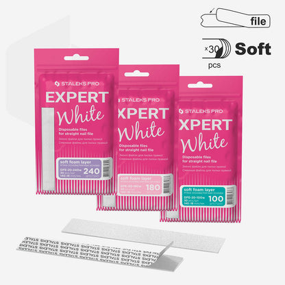 Three packs of Staleks PRO Expert 20 Disposable White Files (100, 180, 240 grit) on soft foam layers in pink packaging. Each pack has 30 adhesive-backed nail file strips by Staleks.