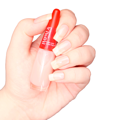 A hand with long, natural nails holds a bottle of Impala Treatment Strengthening Base Coat for Weak Nails 7.5 ml against a white background—ideal for those seeking an effective nail strengthening solution.