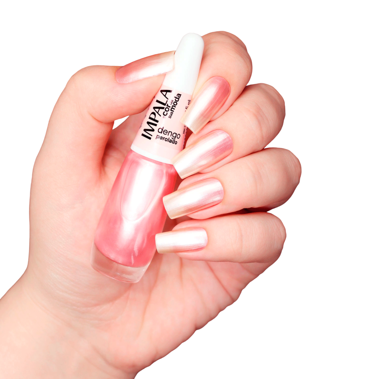 A hand with long, natural nails painted light pink holds an IMPALA Regular Nail Polish Pearlescent Soft Rosé Dengo Perolado 7.5 ml bottle from Impala against a white background.