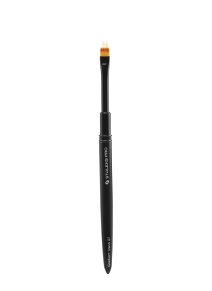 The Staleks PRO Brush For Gradient EXPERT (7mm x 11mm) by Staleks features a black handle and oval, flat head with yellow and white synthetic bristles for precise makeup application, shown upright on a plain background.