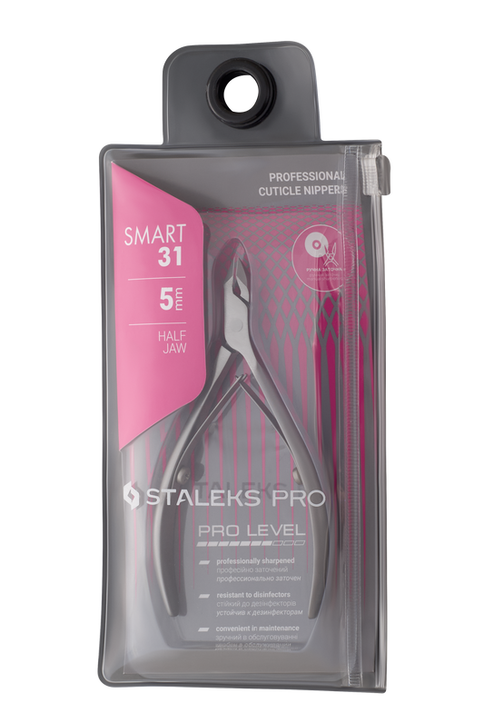 Staleks' STALEKS PRO Smart 31 professional cuticle nippers, featuring a half jaw and sharp edges, come in a transparent pouch with pink accents. The stainless steel tool is disinfection-resistant and easy to maintain.