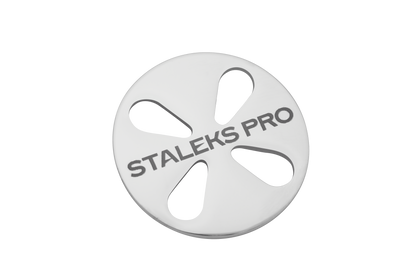 A round, silver-colored STALEKS PRO Pedicure Disc PODODISC by Staleks, featuring five teardrop-shaped cutouts and "STALEKS PRO" engraved on the stainless steel surface. Includes a set of 5 disposable files. Black background.
