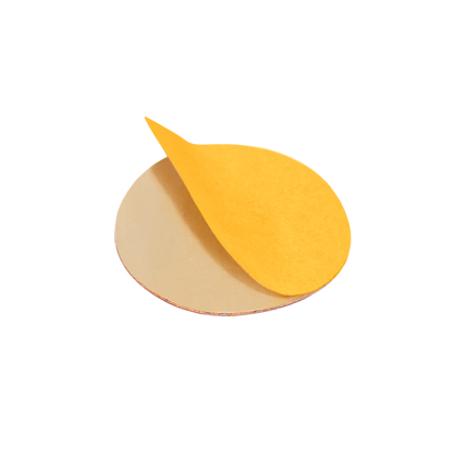 A round yellow STALEKS PRO Disposable file for pedicure disc PODODISC L EXPERT (25mm) by Staleks, with an edge peeled back to show the adhesive underside, is displayed against a plain white background.