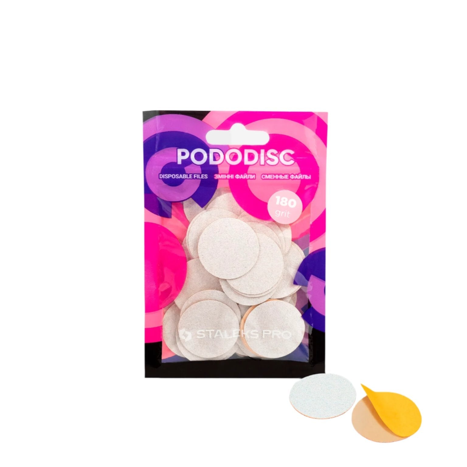 A Staleks pack labeled "STALEKS PRO Disposable files for pedicure disc PODODISC L EXPERT (25mm) / 50pcs" contains round white pads, some displayed outside with one flipped to show its yellow adhesive and abrasive grit.