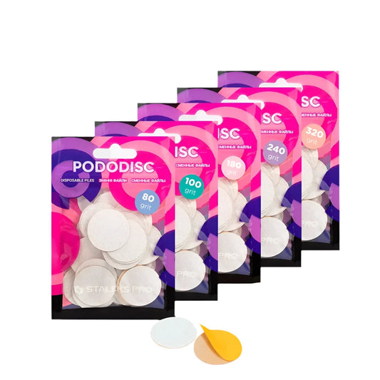 Five packets of Staleks STALEKS PRO Disposable files for pedicure disc PODODISC L EXPERT (25mm, 50pcs) in grits 80, 100, 180, 240, and 320 are arranged in a row, with two individual discs displayed in front.
