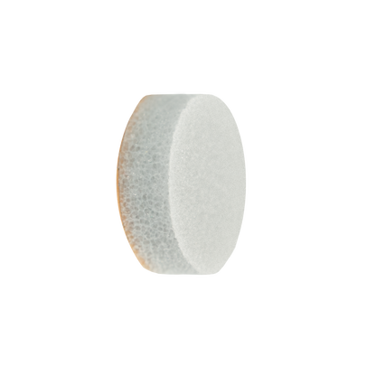 A single white, round, textured STALEKS PRO Disposable Sponge File for the PODODISC S EXPERT 15 (25 pcs) by Staleks is shown against a black background, resembling the surface of a pedicure file used for smooth feet.