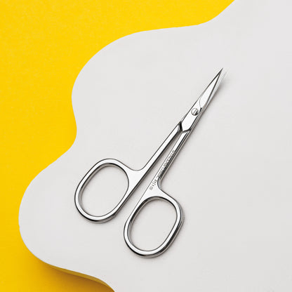 The STALEKS PRO Cuticle Scissors CLASSIC 21 TYPE 1 by Staleks, featuring stainless steel and rounded handles, rest on a white surface against a bright yellow background—an ideal tool for manicures and pedicures.