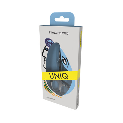 A box of Staleks STALEKS PRO Professional Cuticle Scissors Asymmetric UNIQ 30 TYPE 4 with modern face graphics, colorful accents on the packaging, and the scissors visible through a clear window.