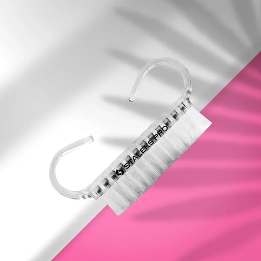 The Staleks STALEKS PRO Manicure Brush EXPERT 02 for dust removal (10 pcs) features durable plastic with synthetic bristles, shown on a pink and white background with soft shadows.