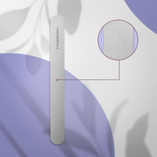A close-up of the Staleks PRO Laser Nail File EXPERT 10 (165 mm) on a purple and white background, featuring a magnified view of its textured stainless steel surface—perfect for detailed manicures and pedicures.