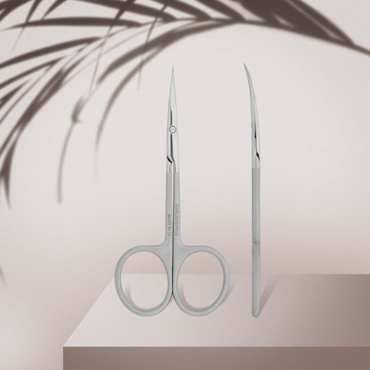 The STALEKS PRO Professional Cuticle Scissors SMART 10 TYPE 3 by Staleks are shown upright—one with a front view, the other side profile—against a light background with palm leaf shadows.