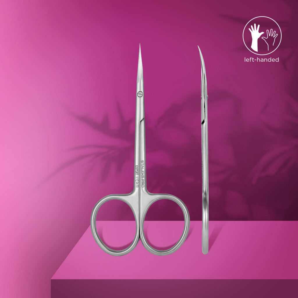 The STALEKS PRO Professional Cuticle Scissors For Left-Handed Users EXPERT 11 TYPE 3 by Staleks are shown upright and side-on on a pink surface with a magenta background, featuring a left-handed icon in the top right corner.