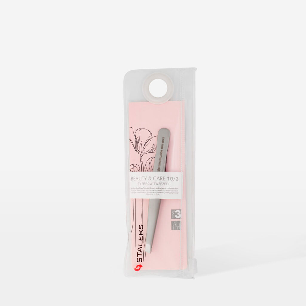 The STALEKS PRO Eyebrow Tweezers BEAUTY & CARE 10 TYPE 3 (wide beveled) come in a pink and transparent floral case, ideal for shaping thick brows. Includes a circular hole at the top for hanging display. Brand: Staleks.