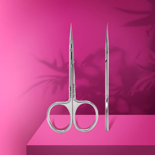 Two STALEKS PRO Professional Cuticle Scissors With Hook For Left-Handed Users EXPERT 13 TYPE 3 by Staleks are shown against a bright pink background, one forward and one side view, with soft leaf shadows in the back.